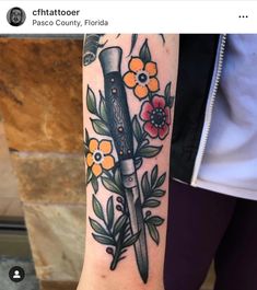 a knife with flowers on it is shown in this tattoo artist's facebook page