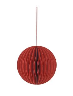 a red paper ball hanging from a string