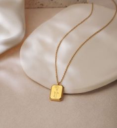 Our jewelry comes ready to gift with a Anavia gift box, blank card, and a organza bag. | The lovely 18k gold square pendant features a shiny polished surface engraved with the birth flower representing each month. Material: Stainless SteelSize: 6/8" x 1/2"Chain: 18"+2" cable Chain | 1-800-Flowers Gifts Delivery 18K Gold Plated Rectangle Birth Flower Necklace 18K Gold Plated Rectangle October Marigold Birth Flower Necklace