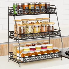 three tiered spice rack with jars and spices