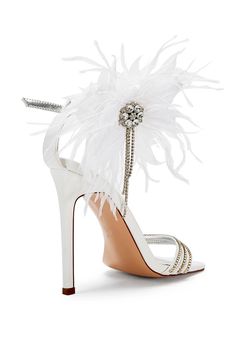 a white high heel shoe with feathers on it