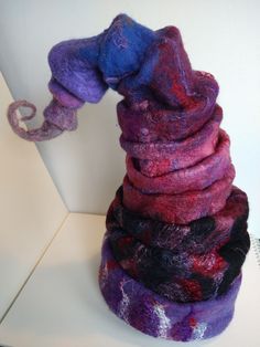 Fun & funky, hues of purples and magentas with silky accents, this wizard's hat will set you apart from all those pretenders!!!!! One of a kind! wet-felted with merino wool and specialty silk & coconut fibers Purple Whimsical Winter Hat, Whimsical Purple Winter Hat, Wizard Hat, Wet Felt, Coconut Fiber, Fantasy Fashion, Wizard, Merino Wool, Coconut