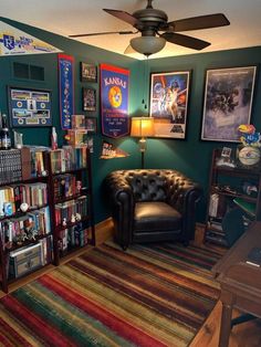 a living room filled with lots of books and furniture next to a book shelf full of movies