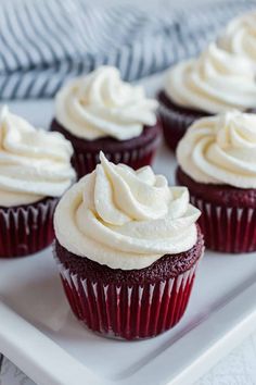 red velvet cupcakes with white frosting on top