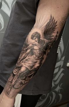 a man's arm with an angel tattoo on it