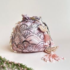 A delicately embroidered blush potli bag, embellished with sequins on a layer of net fabric and silk material.  There is a statement chain handle which adds a luxury feel to the bag and and can be worn effortlessly over the wrist to carry your essentials. Dimensions: 22cm x 20cm Pink Bags For Evening And Festivals, Bohemian Embellished Potli Bag As Gift, Luxury Embellished Potli Bag As Gift, Luxury Pearl Embroidered Potli Bag For Party, Elegant Pink Potli Bag For Festivals, Elegant Pink Embroidered Potli Bag, Glamorous Festive Potli Bag, Reception Potli Bag With Pearl Embroidery, Festive Pink Embroidered Pouch