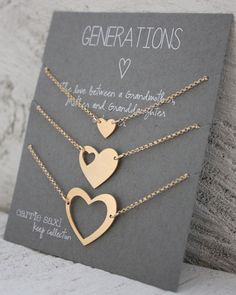 three gold heart necklaces on a card