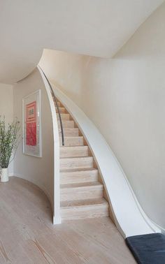 an image of a room with stairs and plants in the corner on the phone screen