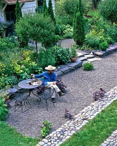 a person sitting at a table in a garden