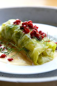 a plate with some food on it and garnished in cranberry sauce