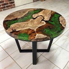 a table with green moss and rocks on it in front of a brick wall or floor