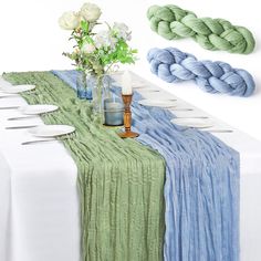 the table is set with blue, green and white linens on top of it