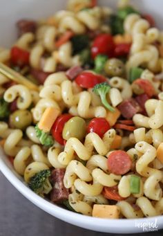 a pasta salad with broccoli, tomatoes, and other vegetables