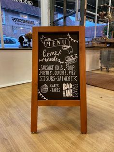 a menu board sitting on top of a hard wood floor