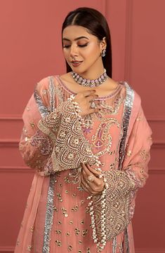 Peach Pink Heavily Embroidered Pakistani Salwar Kameez Party Wear is fully decorated with work of dabka, beads, and pearls on a lehenga shirt in the pink color along with a Dupatta made in net having sprayed embroidery. This dress can be customized into salwar kameez instead of lehenga kameez. Pink Shirt Lehenga: Nameera by Farooqs superb new collection features this outstanding traditional net kameez, encrusted with hand-crafted artistry over royal hues. The light pink, french net shirt is heav Pakistani Boutique, Pakistani Salwar, Salwar Dress, Dress Salwar Kameez, Net Lehenga, Pakistani Salwar Kameez, Chiffon Collection, Embroidered Chiffon, Net Dupatta