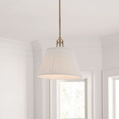 a light fixture hanging from the ceiling in a room with white walls and flooring