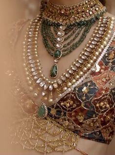 a close up view of a woman's necklaces and jewelry