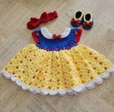 a crocheted dress and shoes on the floor