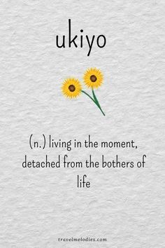 two yellow flowers sitting on top of a piece of paper with the words ukiyo