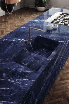 a blue marble counter top with a sink and faucet