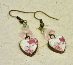 These are rustic pink and red heart earrings are paired with vintage pink and green Czech beads and antique bronze ear wires.  I love the handmade ceramic red, pink flowers on the hearts. The ceramic hearts are by British artisan Natalie McKenna of Grubbi.   They are light and comfortable on the ears.  The pretty earrings hang about 1.75 inches in length.    They make a lovely birthday present, or Valentine gift. All of my jewelry is shipped in eco friendly craft boxes wrapped with a bow.  They Pink Heart-shaped Flower Earrings For Gift, Pink Heart-shaped Flower Earrings As Gift, Vintage Pink Heart Earrings For Valentine's Day, Red Heart Earrings, Casual Earrings, Broken China Jewelry, China Jewelry, Heart Shaped Earrings, Stained Glass Crafts