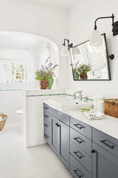 a large bathroom with two sinks and mirrors