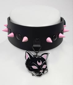 Genuine black leather, 40mm wide. Roller buckle in the back for closing. Acrylic witchy cat pendant. Pink spikes, 10mm high. Comfortable and easy to wear. Style: kawaii, harajuku, grunge, punk rock, witchy, gothic Adjustable Emo Choker For Cosplay, Handmade Edgy Choker For Halloween, Black Punk Choker For Cosplay, Edgy Black Choker For Cosplay, Cute Adjustable Black Choker, Handmade Punk Black Choker, Handmade Black Punk Choker, Black Emo Choker For Cosplay, Adjustable Punk Choker For Cosplay