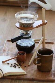 three tiered tray with coffee cups and an open book