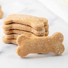 four dog biscuits stacked on top of each other with a bone shaped cookie in the middle