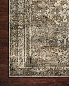 an antique rug on a wooden floor with dark wood floors and white trimmings