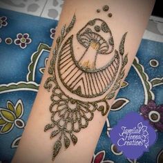 a henna tattoo is on the arm of a woman