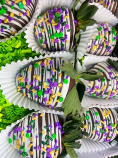 chocolate covered strawberries with sprinkles and green leaves on display for sale