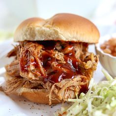 a pulled pork sandwich with coleslaw on the side