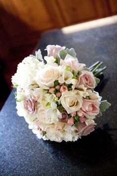 a bridal bouquet sitting on top of a table