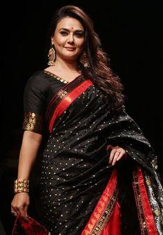 a woman in a black and red sari