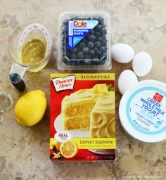 ingredients to make lemon blueberry cake laid out on a table