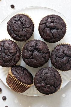 chocolate muffins on a plate with coffee beans