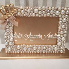 a gold frame with pearls and a bow