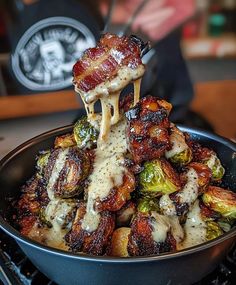 a pan filled with bacon and brussel sprouts covered in melted cheese