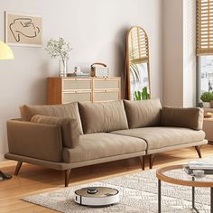 a living room filled with furniture and a large window covered in blinds next to a wooden coffee table