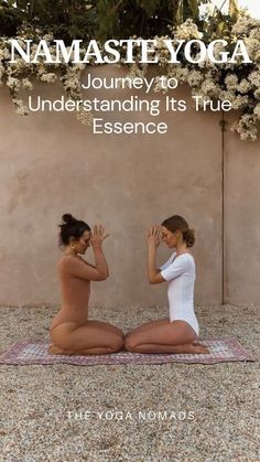 two women sitting on the ground in yoga poses