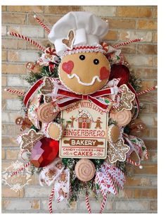 a gingerbread christmas wreath hanging on a brick wall