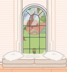 there is a bed with two pillows in front of a window that has a cartoon scene on it