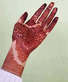 a woman's hand with henna on it