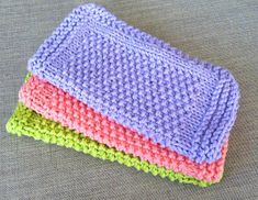 three crocheted dishcloths sitting next to each other on top of a table