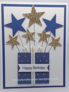 a birthday card with blue and gold stars in the shape of a gift box on it