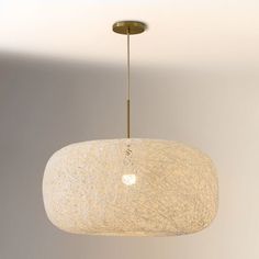 a white lamp hanging from a ceiling in a room