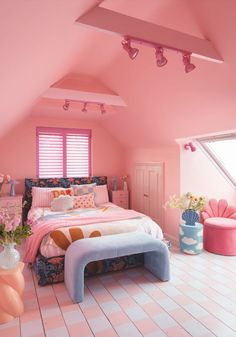 a bedroom with pink walls and flooring in the room is decorated like a bed