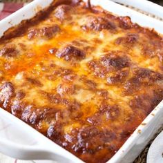 a casserole dish with cheese and meat in it