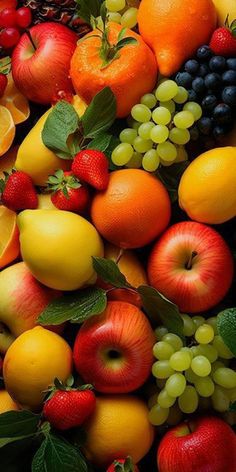 an assortment of fruit including oranges, apples, grapes and strawberries is shown